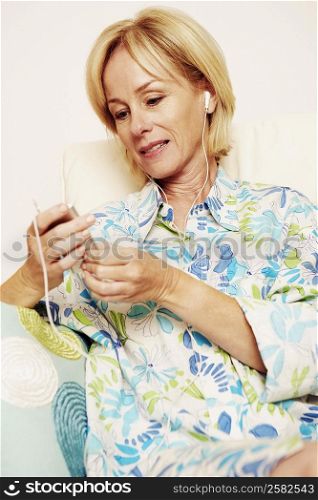 Close-up of a mature woman listening to an MP3 player