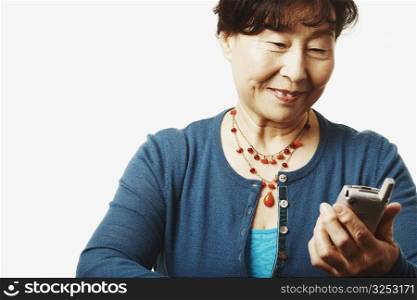 Close-up of a mature woman looking at a mobile phone