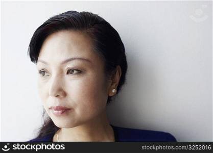Close-up of a mature woman looking sideways thinking