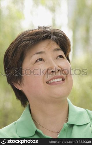 Close-up of a mature woman looking up and smiling