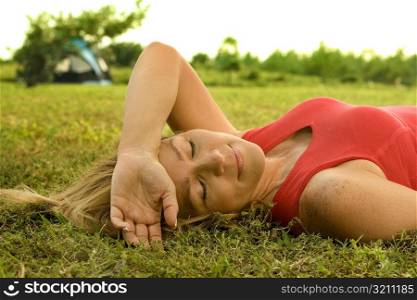 Close-up of a mature woman lying on the grass