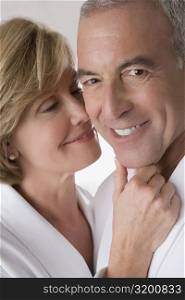 Close-up of a mature woman romancing with a senior man and smiling