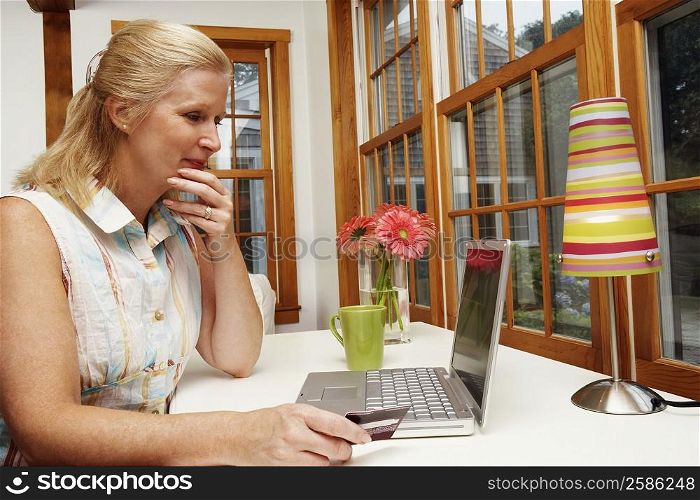 Close-up of a mature woman shopping online