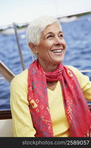 Close-up of a mature woman sitting in a boat and smiling