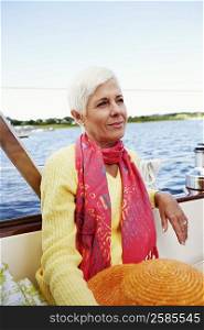 Close-up of a mature woman sitting in a boat and smirking
