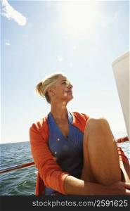 Close-up of a mature woman sitting in a boat and smirking