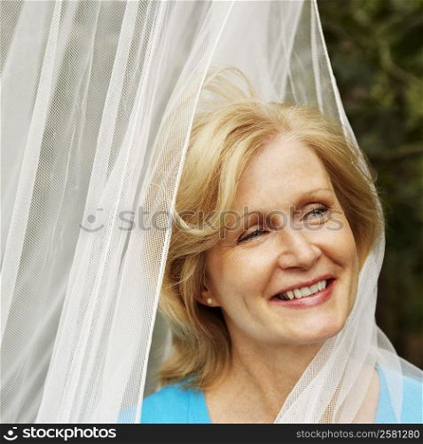 Close-up of a mature woman smiling and looking sideways