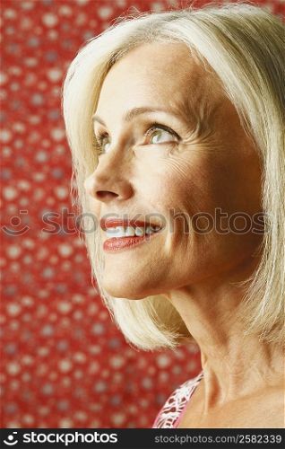 Close-up of a mature woman smiling and looking up