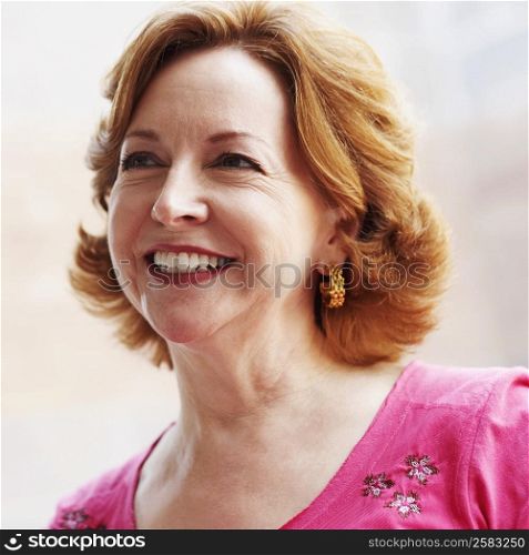 Close-up of a mature woman smiling and looking up
