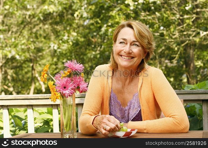 Close-up of a mature woman smiling at the table