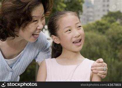 Close-up of a mature woman smiling with her granddaughter