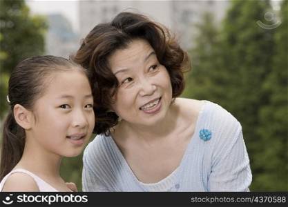 Close-up of a mature woman smiling with her granddaughter