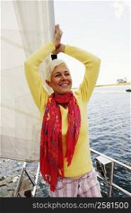 Close-up of a mature woman standing in a sailboat and smiling