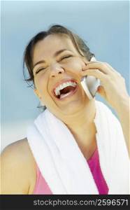 Close-up of a mature woman talking on a mobile phone and laughing