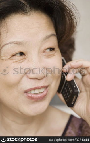 Close-up of a mature woman talking on a mobile phone and smiling