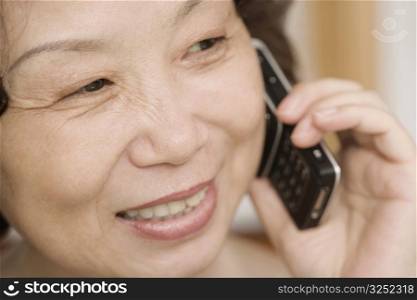Close-up of a mature woman talking on a mobile phone and smiling