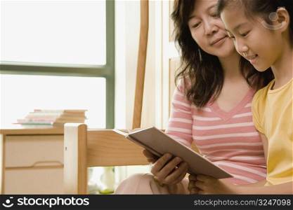 Close-up of a mature woman teaching her daughter
