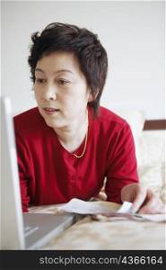 Close-up of a mature woman using a laptop