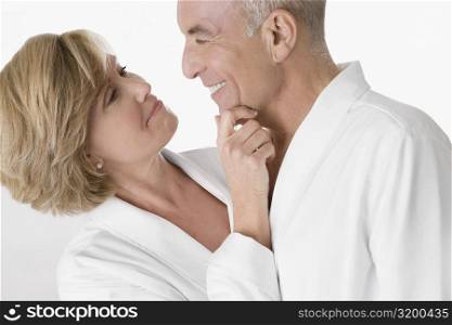 Close-up of a mature woman with a senior man embracing and looking at each other