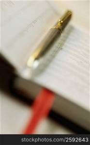 Close-up of a metal pen on a diary