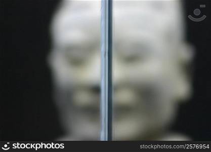Close-up of a metal rod and a statue in the background, Xi&acute;an, Shaanxi Province, China