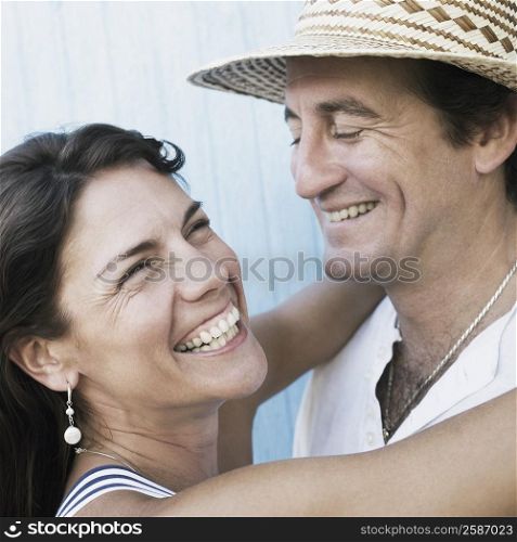 Close-up of a mid adult couple embracing each other and smiling