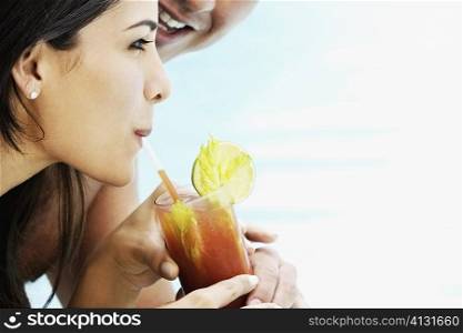Close-up of a mid adult couple holding a glass
