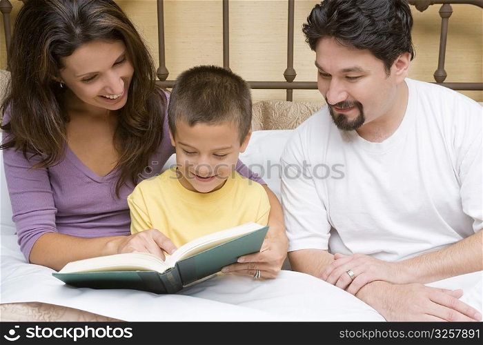 Close-up of a mid adult couple teaching their son