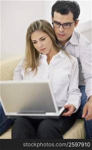 Close-up of a mid adult couple using a laptop