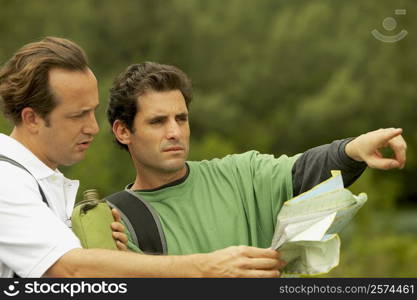 Close-up of a mid adult man and a mature man talking