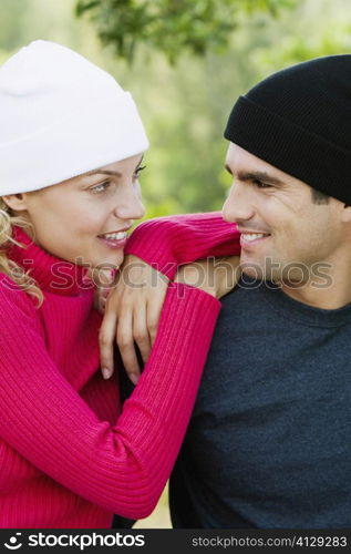 Close-up of a mid adult man and a young woman looking at each other