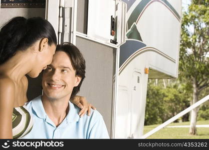 Close-up of a mid adult man and a young woman looking at each other