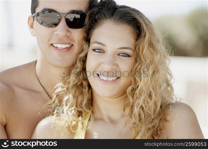 Close-up of a mid adult man and a young woman smiling