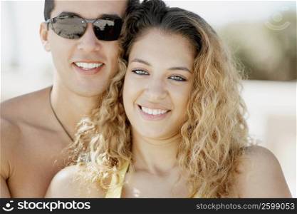 Close-up of a mid adult man and a young woman smiling