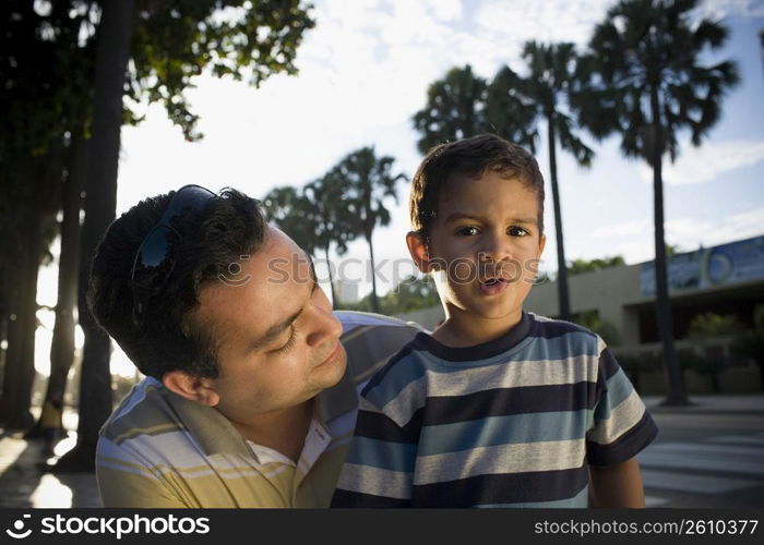 Close-up of a mid adult man and his son, Malecon, Santo Domingo, Dominican Republic