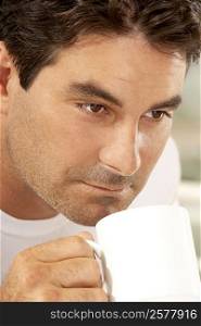 Close-up of a mid adult man drinking a cup of coffee