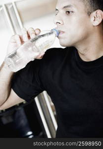 Close-up of a mid adult man drinking water from a water bottle