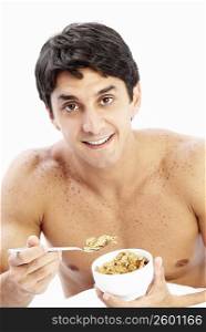 Close-up of a mid adult man holding a bowl of cereal