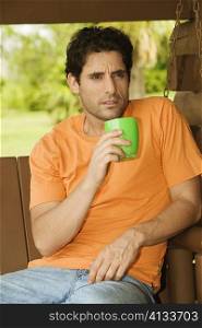 Close-up of a mid adult man holding a coffee cup