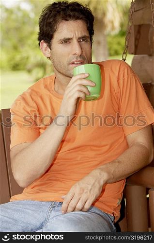 Close-up of a mid adult man holding a cup of tea