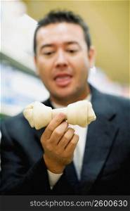 Close-up of a mid adult man holding a dog bone