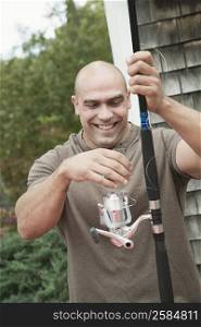 Close-up of a mid adult man holding a fishing rod
