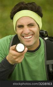 Close-up of a mid adult man holding a flashlight
