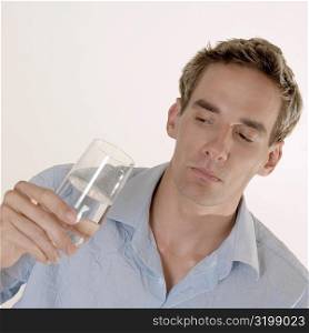 Close-up of a mid adult man holding a glass of water
