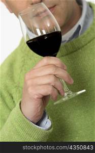 Close-up of a mid adult man holding a glass of wine