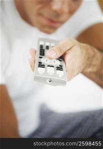 Close-up of a mid adult man holding a remote control