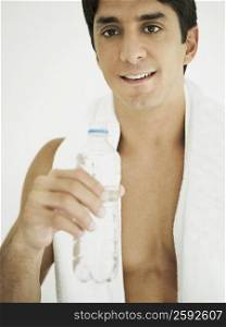 Close-up of a mid adult man holding a water bottle