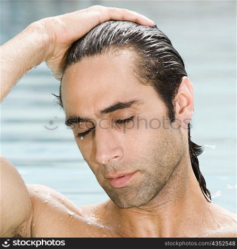Close-up of a mid adult man in a swimming pool with his eyes closed