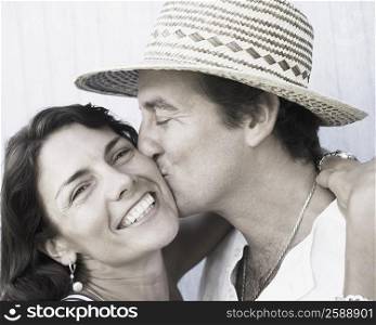 Close-up of a mid adult man kissing a mid adult woman