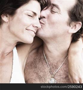 Close-up of a mid adult man kissing a mid adult woman